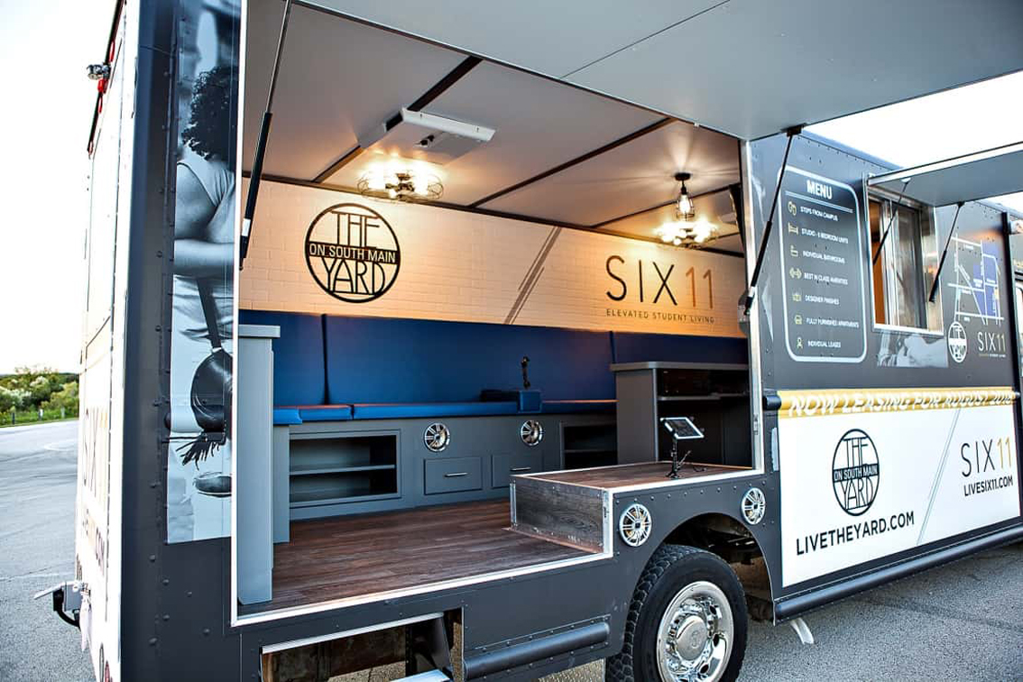Six11 & The Yard Student Living Mobile Office Truck is the latest in innovation when it comes to mobile apartment leasing. It's definitely not your average mobile office truck experience – equipped with a high-end TV/audio system, this Mobile Office truck offers an interactive and inviting atmosphere for potential residents. Six11 & The Yard is smart living for the students, and this mobile office truck is a direct representation of that, which would be a perfect layout to model after, but specify and customize it to your desires.