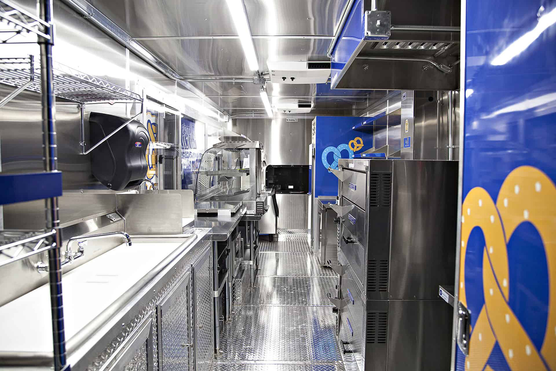 A top tier build by Cruising Kitchens, this Auntie Anne's Food Truck is perfect for businesses looking to produce high quantities of quality soft pretzels. Equipped with state of the art pretzel making equipment and a 4 foot long blow up pretzel, this truck can be customized to fit each business' specific needs.