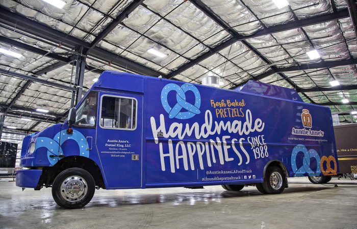 A top tier build by Cruising Kitchens, this Auntie Anne's Food Truck is perfect for businesses looking to produce high quantities of quality soft pretzels. With a 4 foot long blow up pretzel, this truck is sure to stand out at any event!