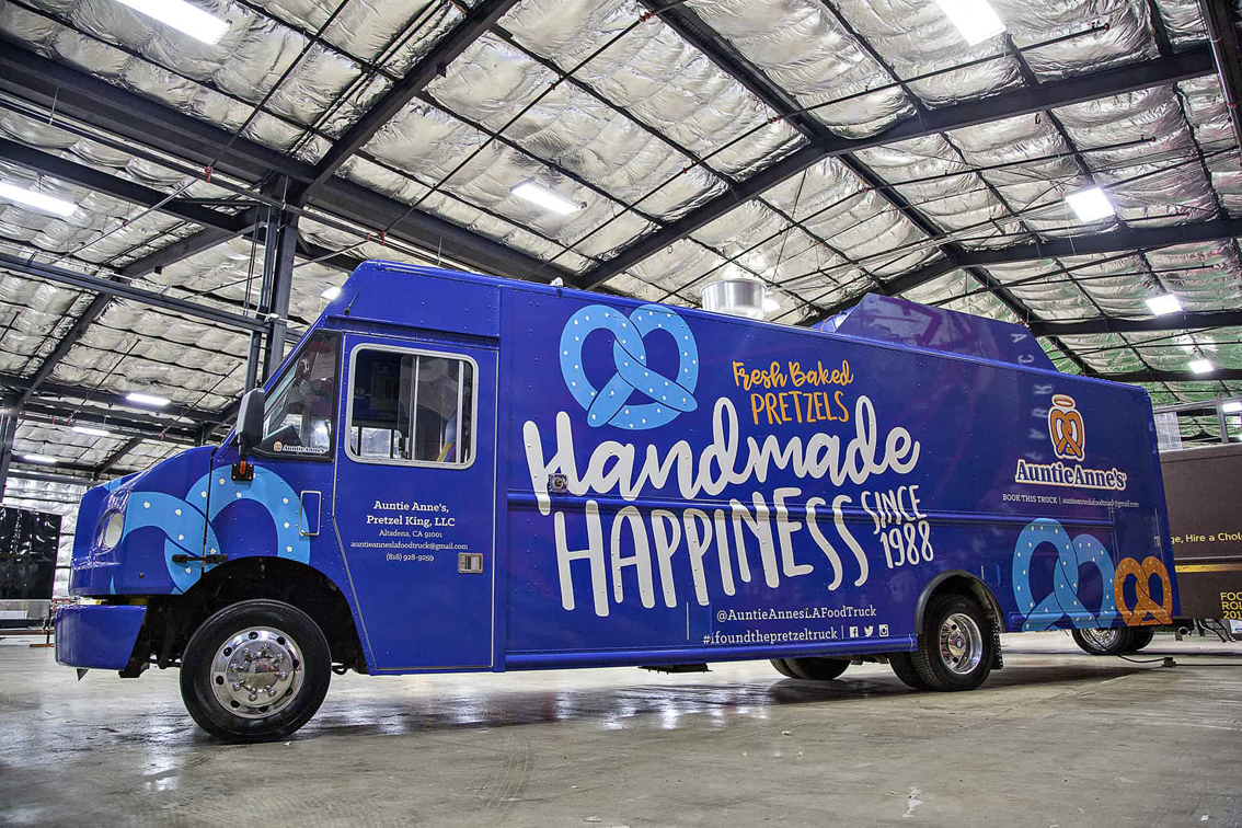 A top tier build by Cruising Kitchens, this Auntie Anne's Food Truck is perfect for businesses looking to produce high quantities of quality soft pretzels. With a 4 foot long blow up pretzel, this truck is sure to stand out at any event!