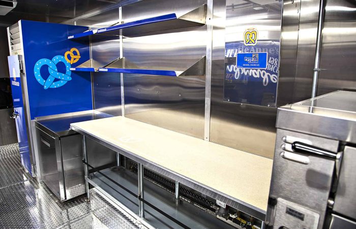 A top-tier build by Cruising Kitchens, this Auntie Anne's Food Truck is perfect for businesses looking to produce high quantities of quality soft pretzels. Equipped with state-of-the-art equipment and a 4 foot long blowup pretzel, this truck can be customized to meet your specific needs.
