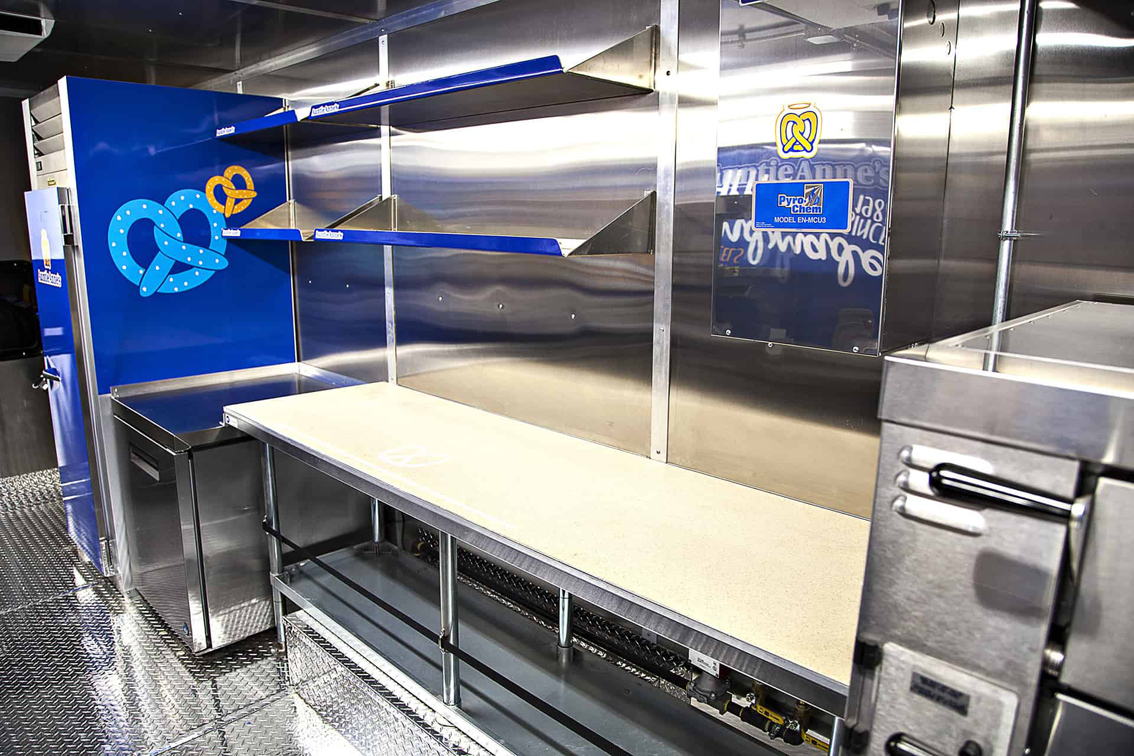 A top-tier build by Cruising Kitchens, this Auntie Anne's Food Truck is perfect for businesses looking to produce high quantities of quality soft pretzels. Equipped with state-of-the-art equipment and a 4 foot long blowup pretzel, this truck can be customized to meet your specific needs.
