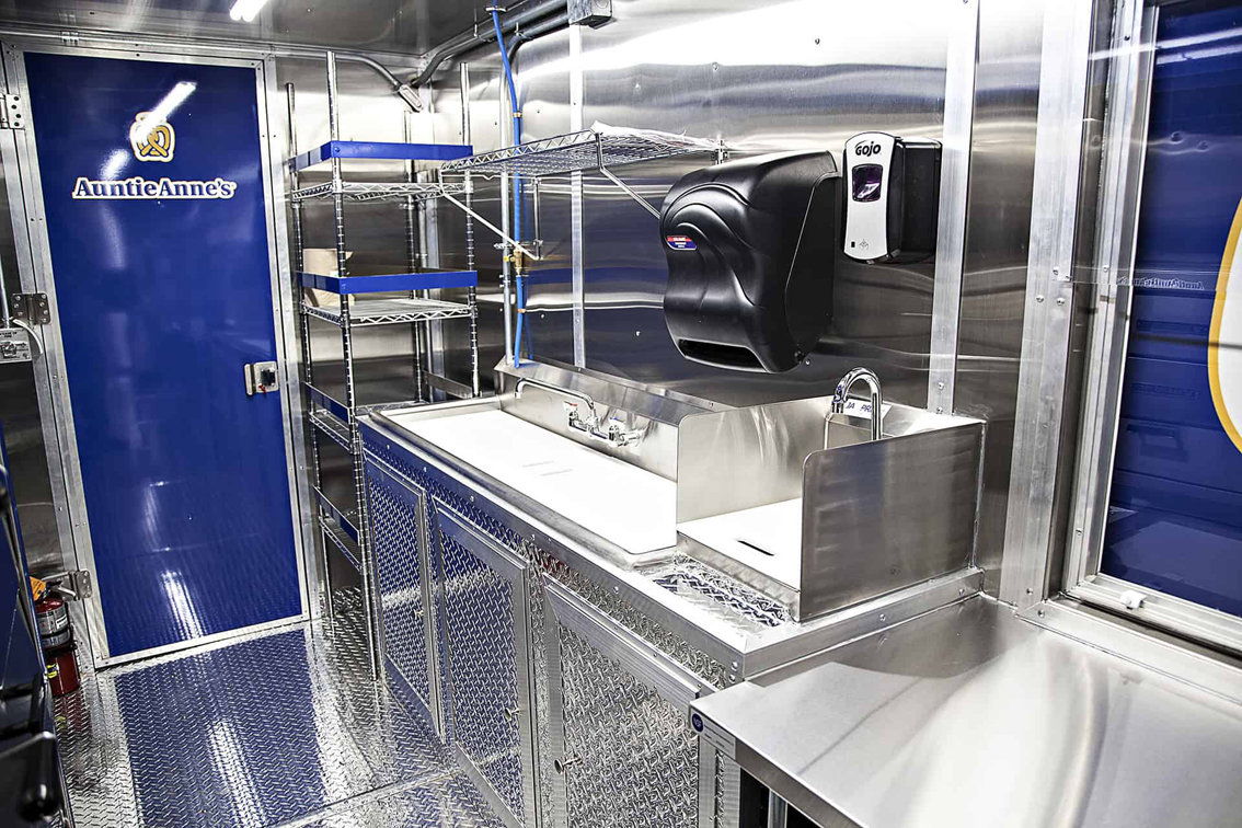 A top tier build by Cruising Kitchens, this Auntie Anne's Food Truck is perfect for businesses looking to produce high quantities of quality soft pretzels. Our team can customize every aspect of the truck to fit your specific needs, from the pretzel making equipment to the 4 foot long blow up pretzel!
