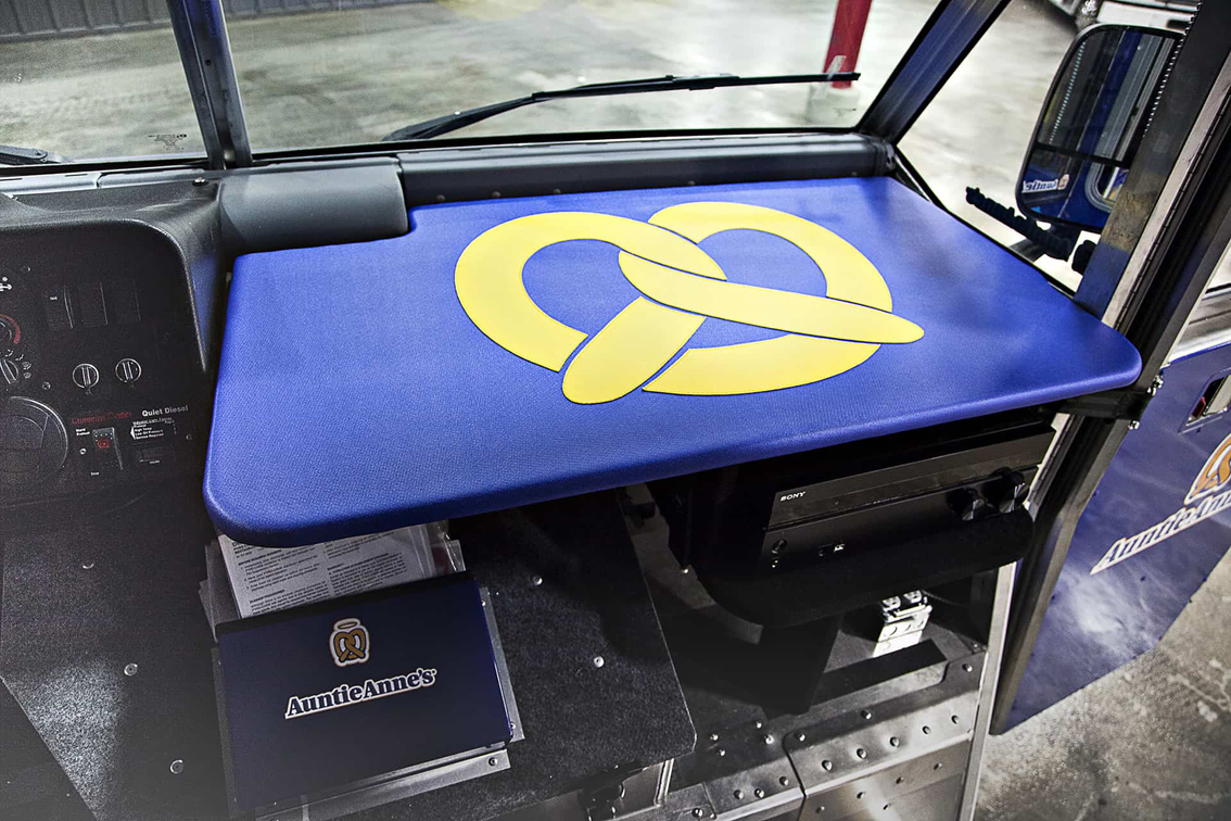 A top-tier build by the Cruising Kitchens expert fabrication team, this Auntie Anne's Food Truck is perfect for businesses looking to produce high quantities of quality soft pretzels. Equipped with state-of-the-art soft pretzel making equipment and a 4 foot long blow up pretzel, this truck can be customized to meet each business' specific needs.