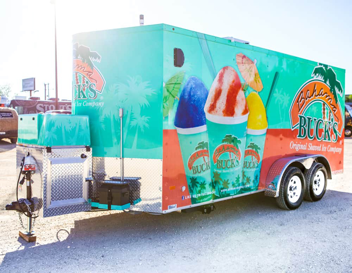 Bahama Bucks Shaved Ice Food Trailer is built by Cruising Kitchens to provide high-quality shaved ice for an exceptional customer experience. The design layout features state of the art ice block shavers, refrigeration, storage, prep tables, and sleek diamond plating all over the interior and graphics package on the wrap exterior.