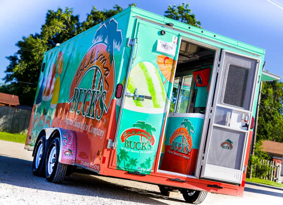 Bahama Bucks Shaved Ice Food Trailer is perfect for high volume shaved ice sales. This design layout utilizes state of the art ice block shavers and refrigeration with sleek diamond plating all over the interior and graphics package on the wrap exterior.