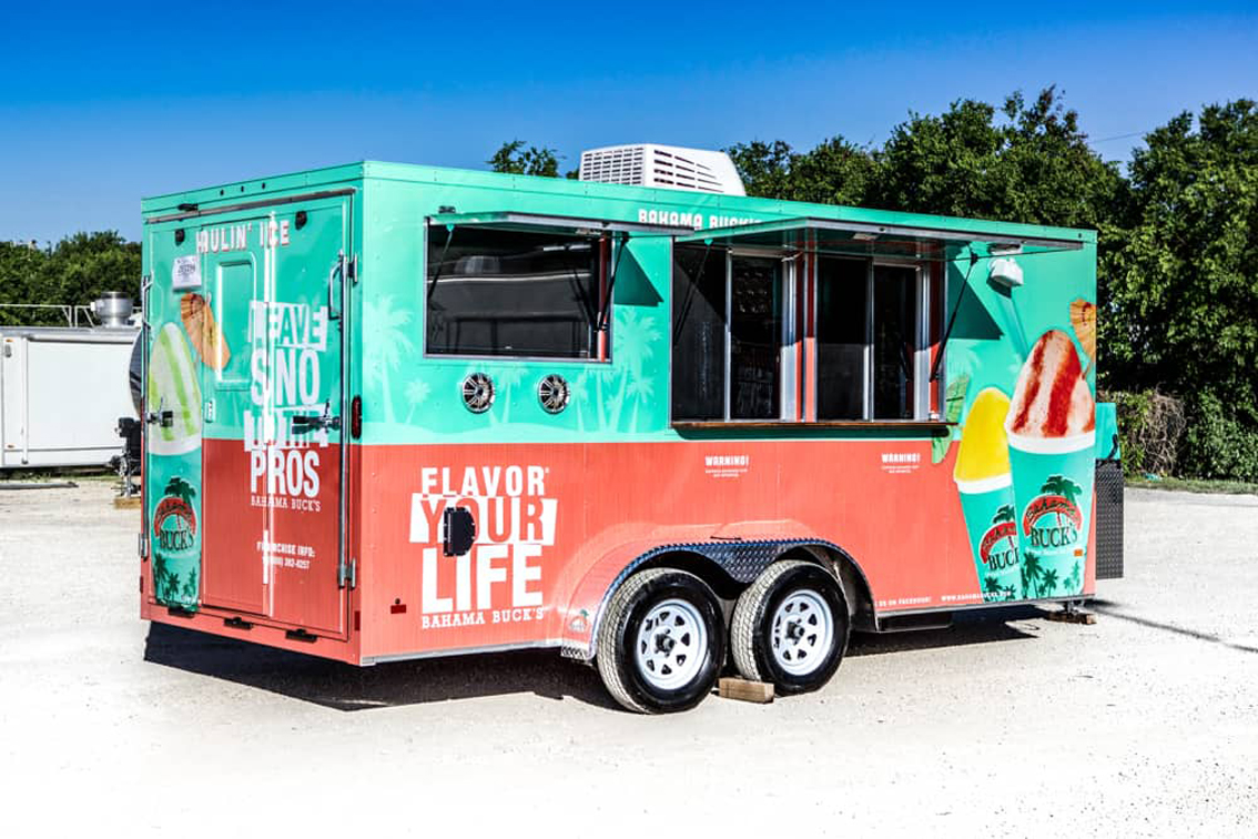 Bahama Bucks Shaved Ice Food Trailer is designed and built by Cruising Kitchens to provide an exceptional shaved ice experience for your customers. With top-of-the-line shavers, refrigeration, and storage, this trailer is perfect for any event.