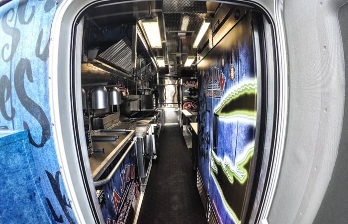 State-of-the-art mobile kitchen custom-built by Cruising Kitchens with top of the line cooking and serving equipment. When customers see this food truck, they know they are in for an unforgettable Cajun culinary experience!