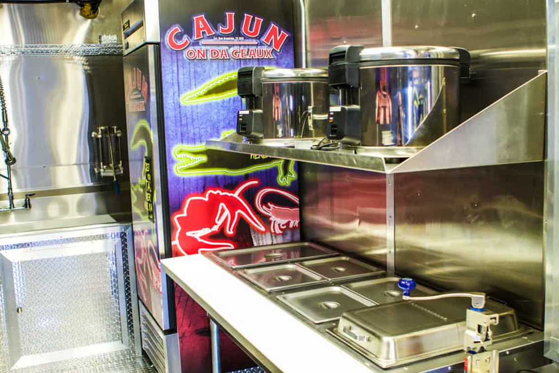 Looking to start a food truck? Cruising Kitchens has you covered with our top of the line mobile kitchens, like this Cajun On Da Geaux Food Truck. Eye-catching and cajun branded through and through, this truck is a perfect model for anyone looking to serve up large quantities and make a splash at any event.