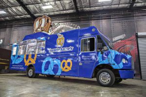 Auntie Anne's Food Truck is a top tier build by Cruising Kitchens expert fabrication team. Custom built to produce high quantities while maintaining quality using state of the art soft pretzel making equipment and topped off with a 4 foot long blow up pretzel.