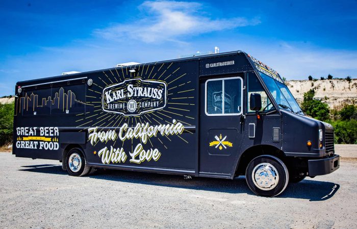Karl Strauss Food Truck is a true innovation for San Diego's Karl Strauss Brewing Company. Built by Cruising Kitchens, this unique food truck features the Karl Strauss logo with contrasting colors and the beautiful San Diego skyline as backdrops. The top-of-the-line commercial appliances provide a quality culinary experience, while the 2 keg taps with ice cold refrigeration not only help to keep beer cool but show off their craft beers. Great food and equipment too.
