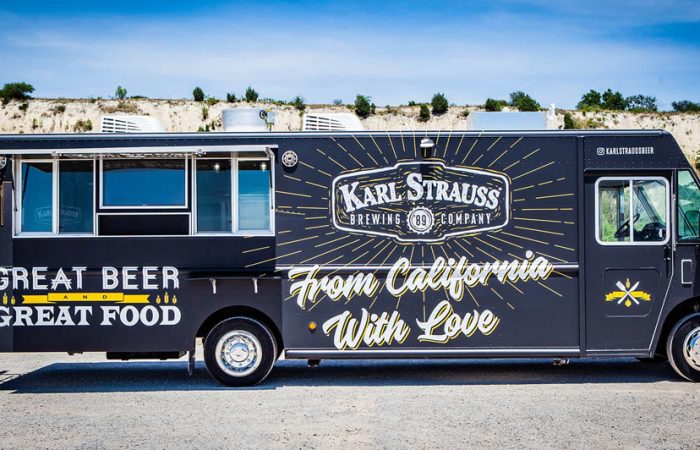 Karl Strauss Food Truck is a true innovation for San Diego's Karl Strauss Brewing Company. Built by Cruising Kitchens, this unique food truck features the Karl Strauss logo with contrasting colors and the beautiful San Diego skyline as backdrops. The top-of-the-line commercial appliances provide a quality culinary experience, while the 2 keg taps with ice cold refrigeration for the kegs. Including quality equipment to serve top of the line bar cuisine.