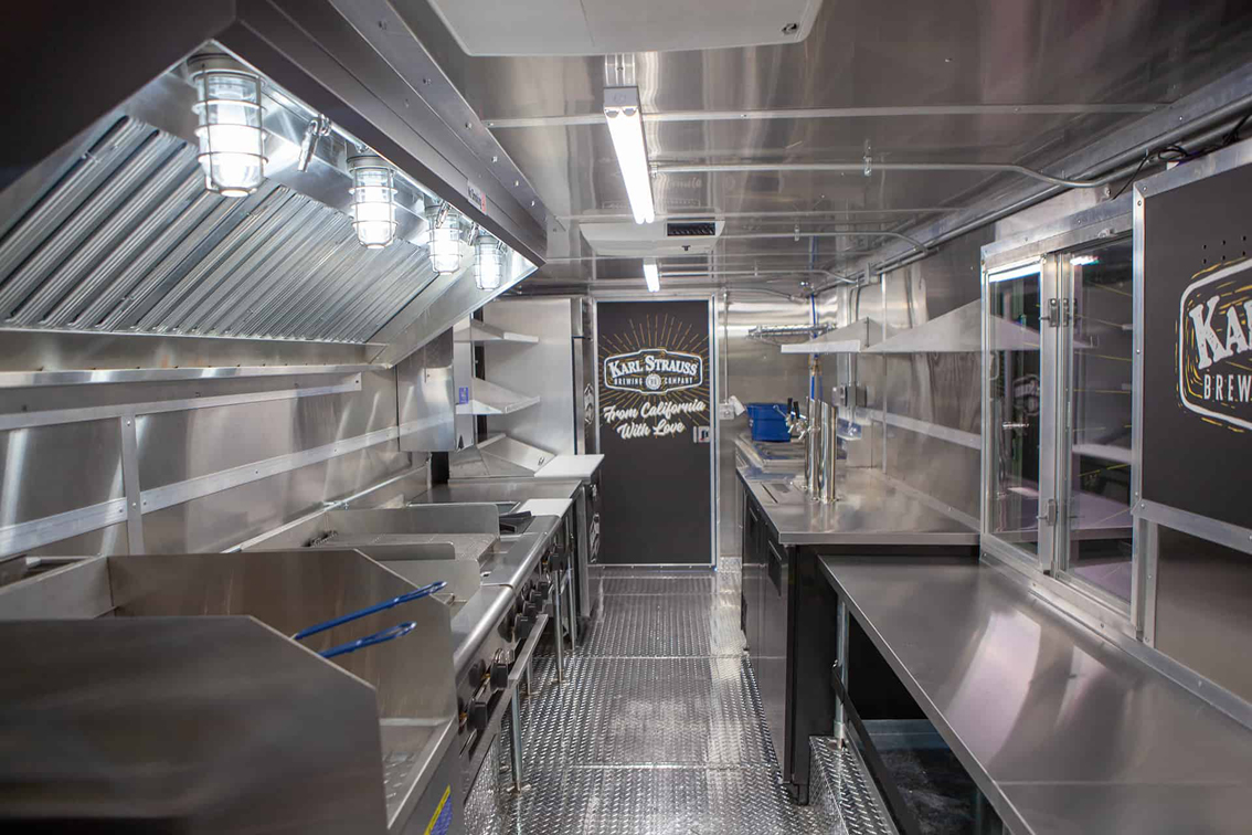 Karl Strauss Food Truck is a custom built food truck by Cruising Kitchens with the Karl Strauss logo and beautiful San Diego skyline as backdrops. This truck features top-of-the-line commercial appliances and 2 keg taps with ice cold refrigeration to help keep beer cool.